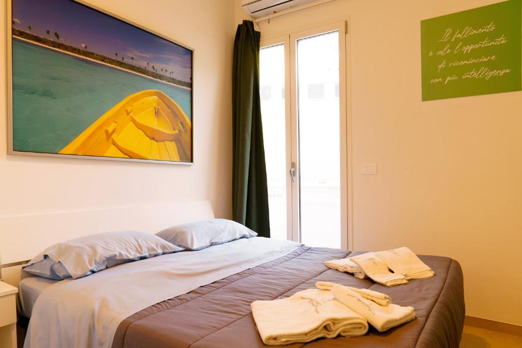 a bedroom with a bed with two towels on it at B&B Casa Cappuccini in Tricase