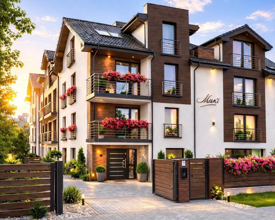 an apartment building with flowerpots on the balconies at Villa Martii - Pokoje Rodzinne z Aneksami in Władysławowo