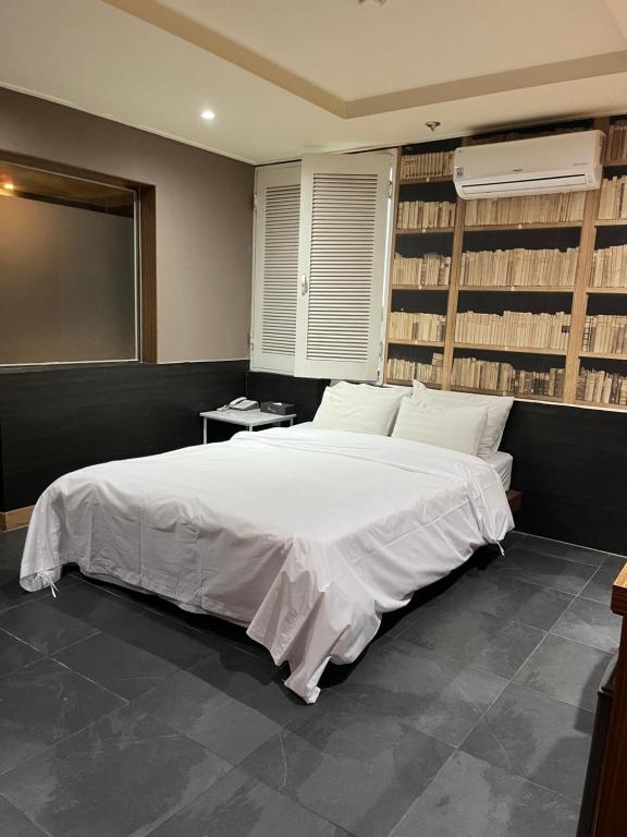 a bedroom with a large white bed in a room at Sixty Hotel in Seoul