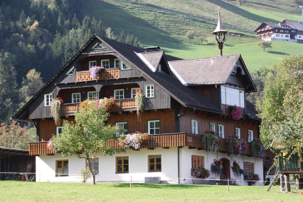 a house with flowers on the balconies of it at Weitgasserhof in Schladming