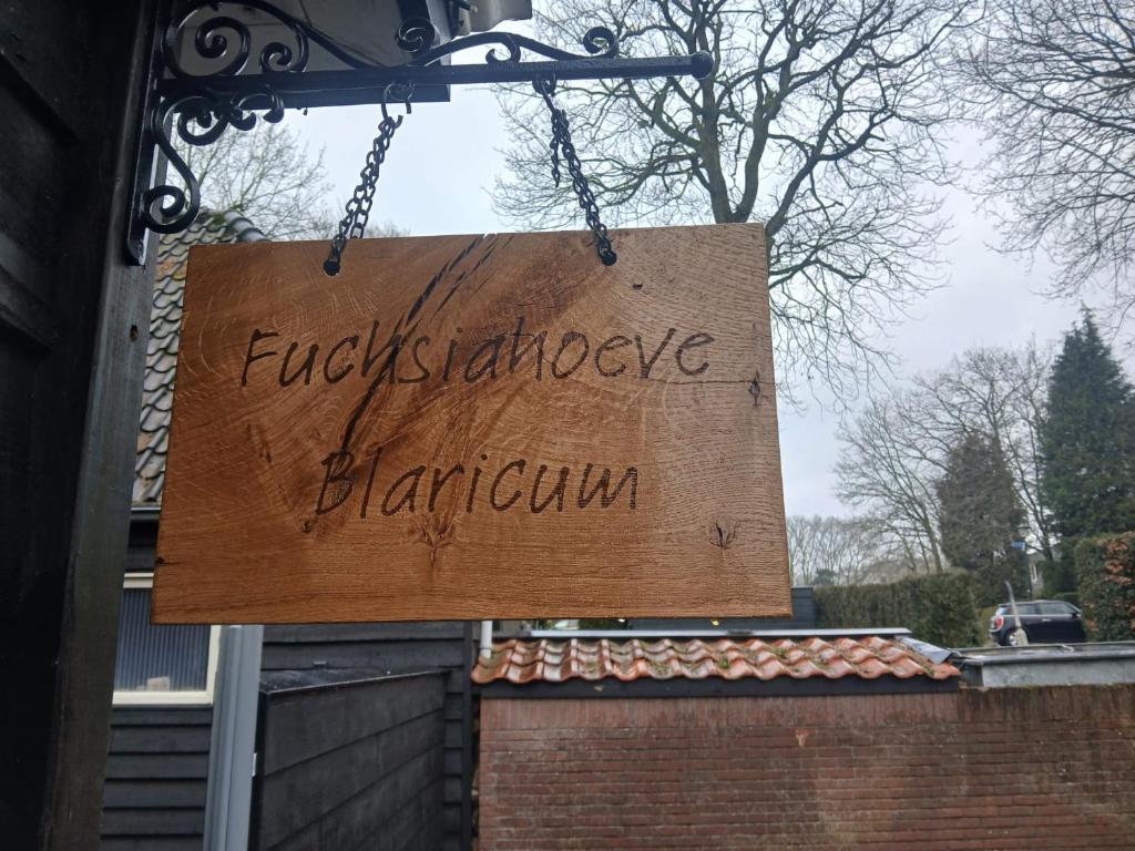 a sign that readsurchesilage hamann hanging from a building at Fuchsiahoeve in Blaricum