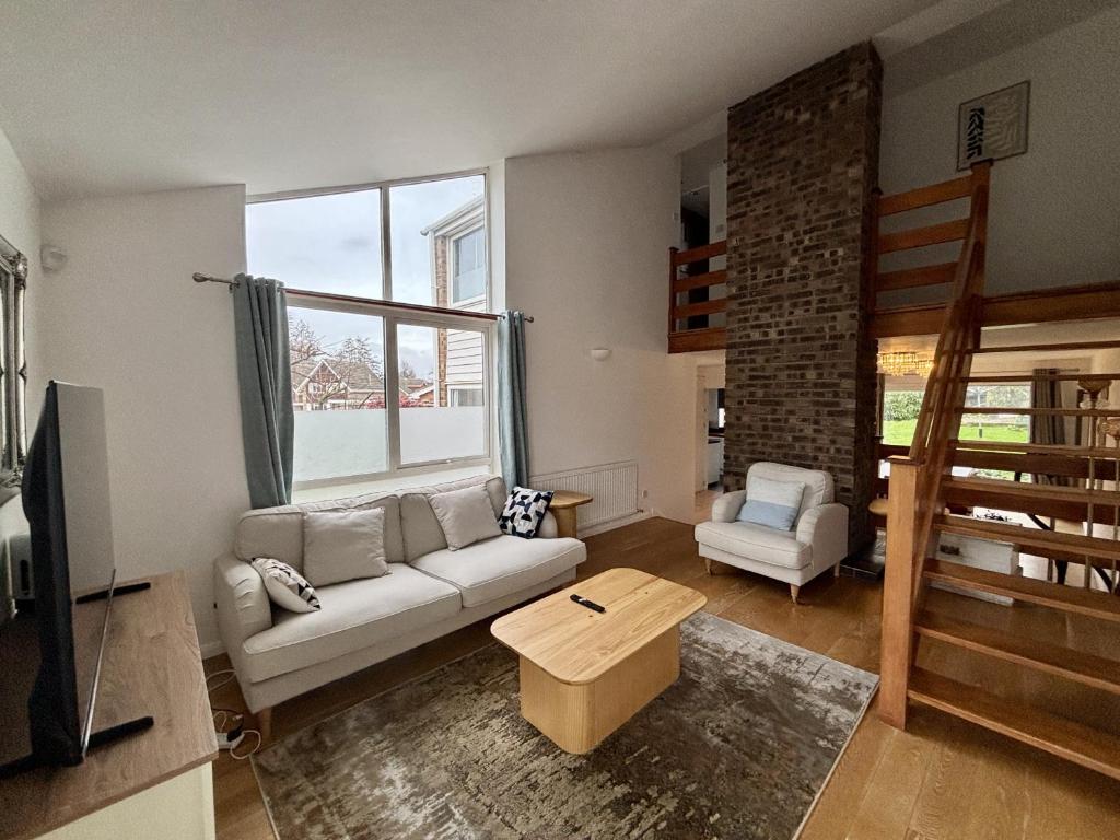 a living room with a couch and a table at Spacious 4-Bed Home in Ascot in Ascot