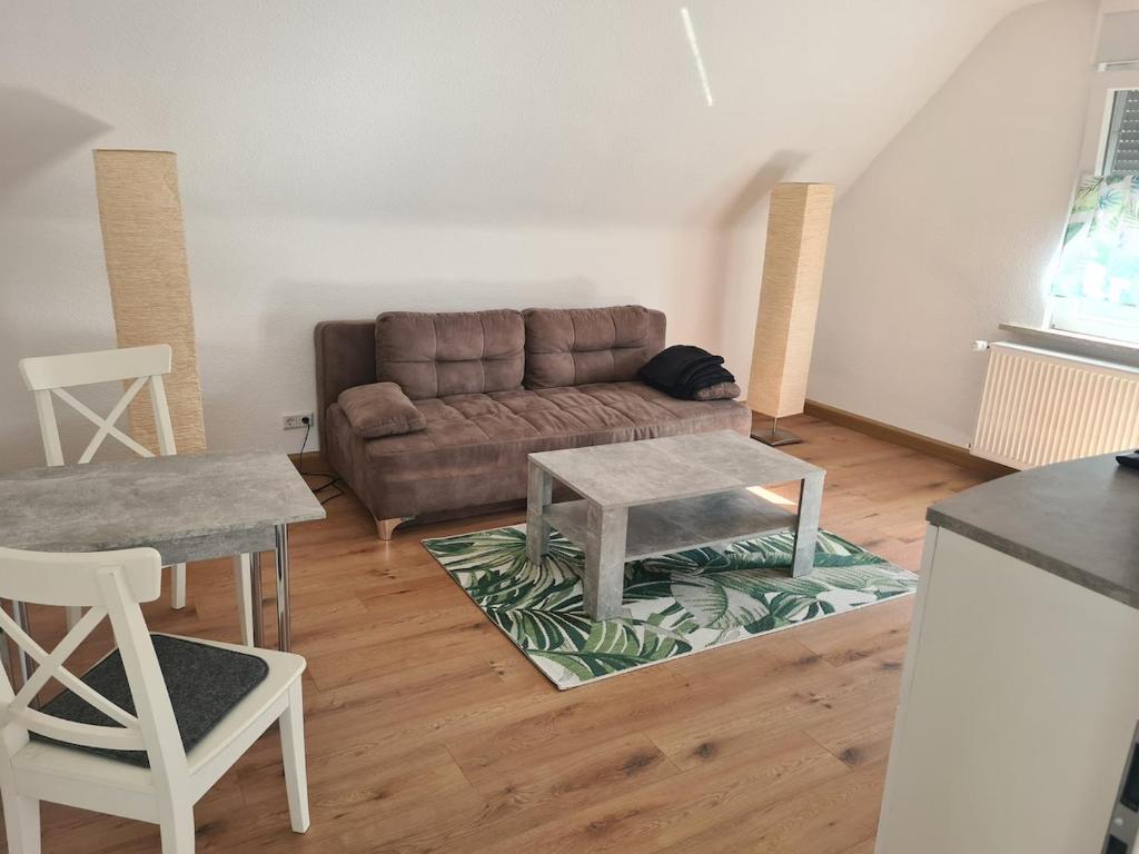 a living room with a couch and a table at Monstera Apartment in Groß-Umstadt