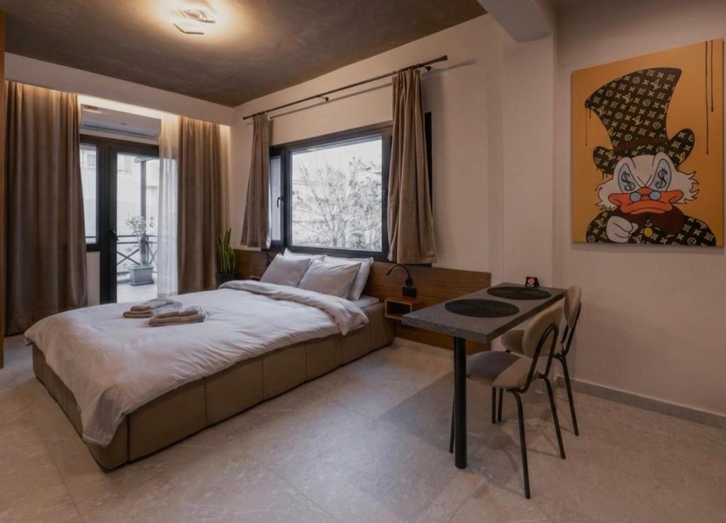 a bedroom with a large bed and a table at Frourio Lodge B2 in Larisa