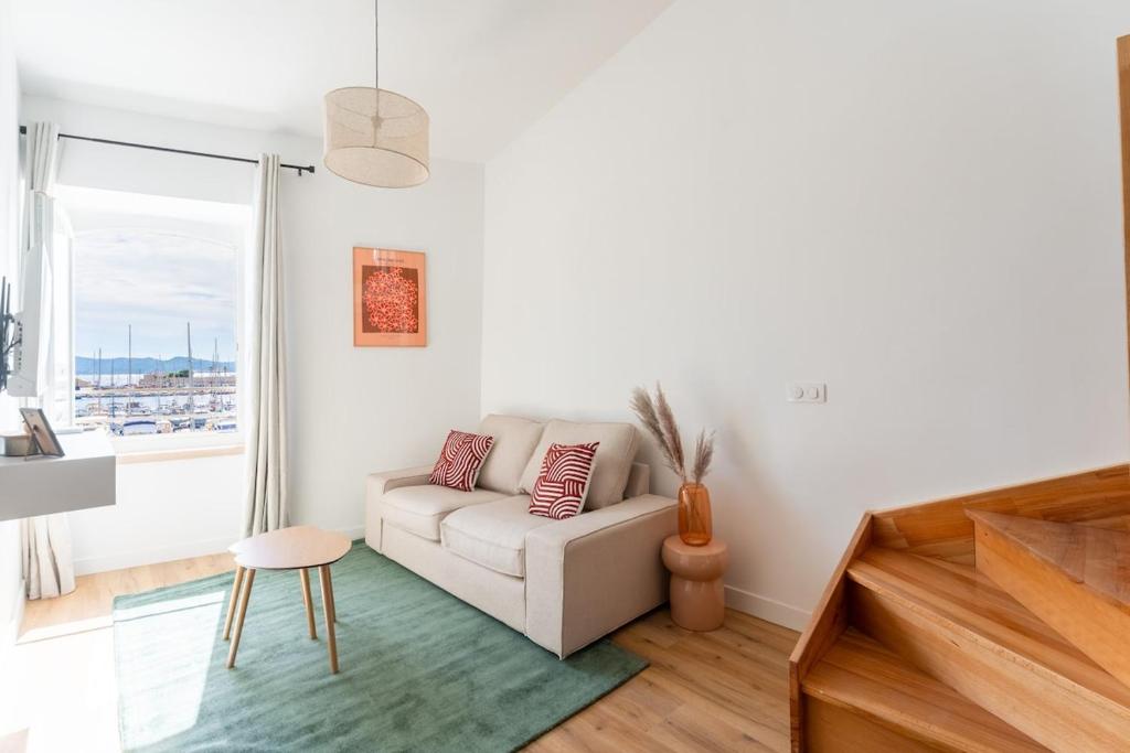 a living room with a couch and a window at Petit Levant in La Ciotat