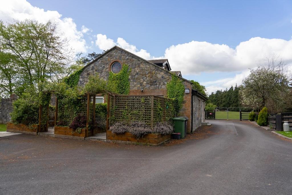 a house with a gate in the middle of a road at Alensgrove Maisonette B in Leixlip