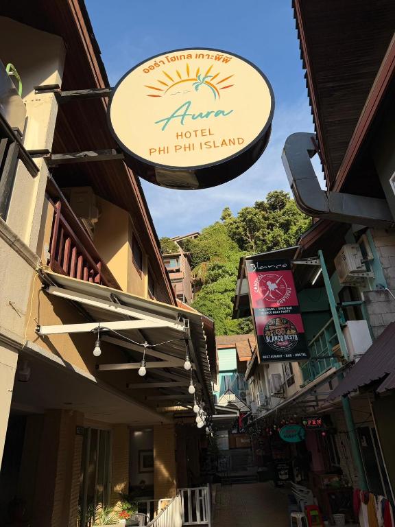 a sign for a hotel on the side of a street at Aura Hotel Phi Phi in Phi Phi Islands