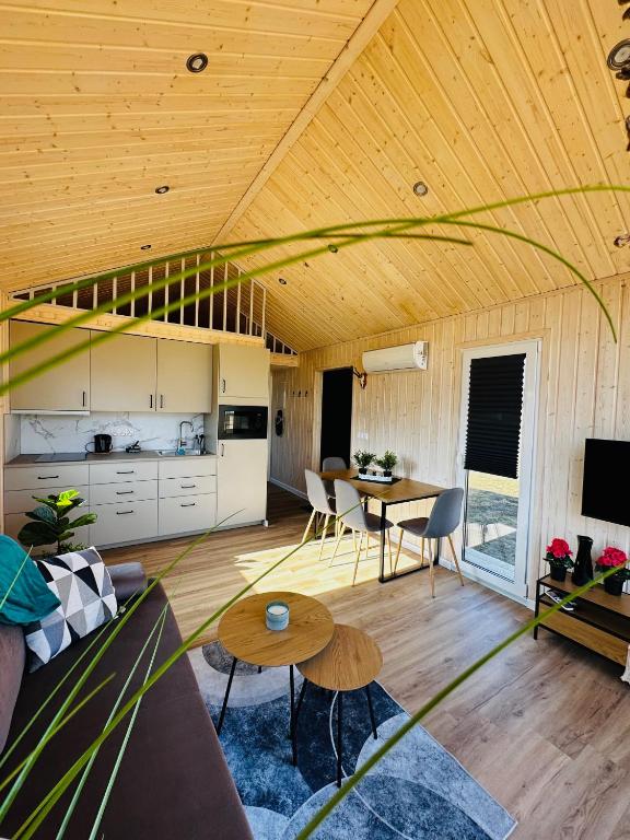 a living room with a couch and a table at Osada Rycerska & Apartamenty Rycerskie in Inowłódz