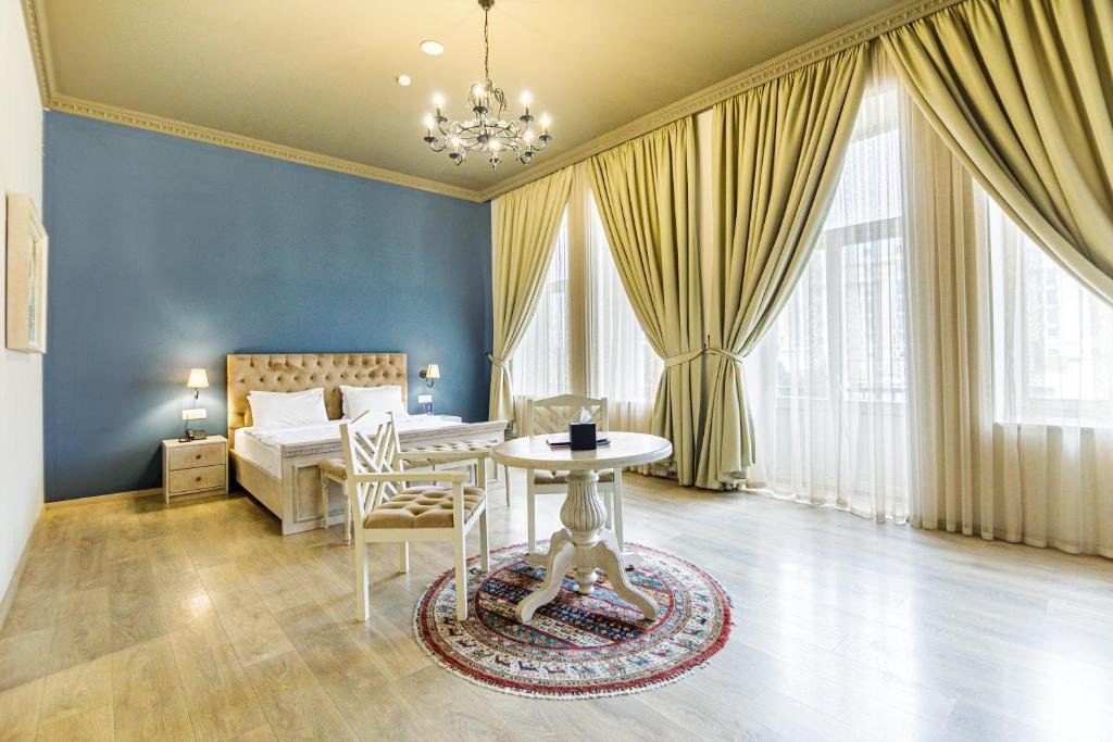 a bedroom with a bed and a table in a room at Art Club in Baku