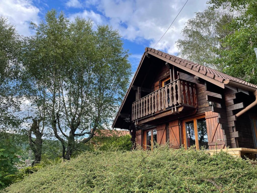 a log cabin with a balcony on a hill at Chalet 6 pers près du lac de Longemer et des pistes in Xonrupt-Longemer