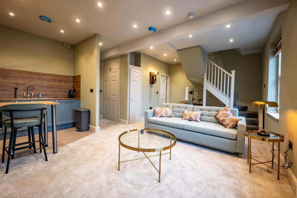 a living room with a couch and a table at The Links Apartments in Newark-on-Trent