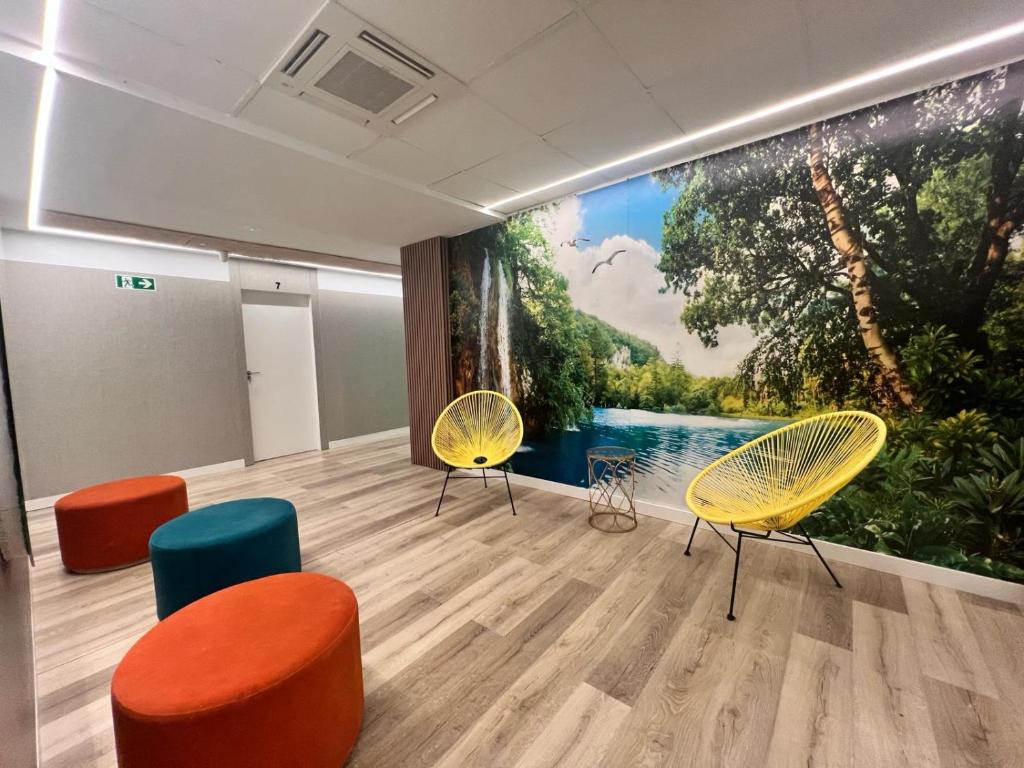 a room with chairs and a large painting on the wall at Abacoa Life in Alicante