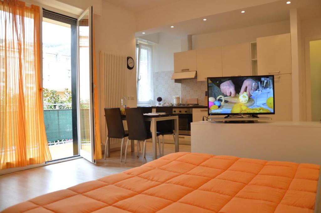 um quarto com uma sala de estar e uma cozinha com uma televisão em Casa Mare em Chiavari