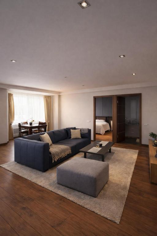 a living room with a couch and a table at Downtown Boulevard View Residence in Šiauliai