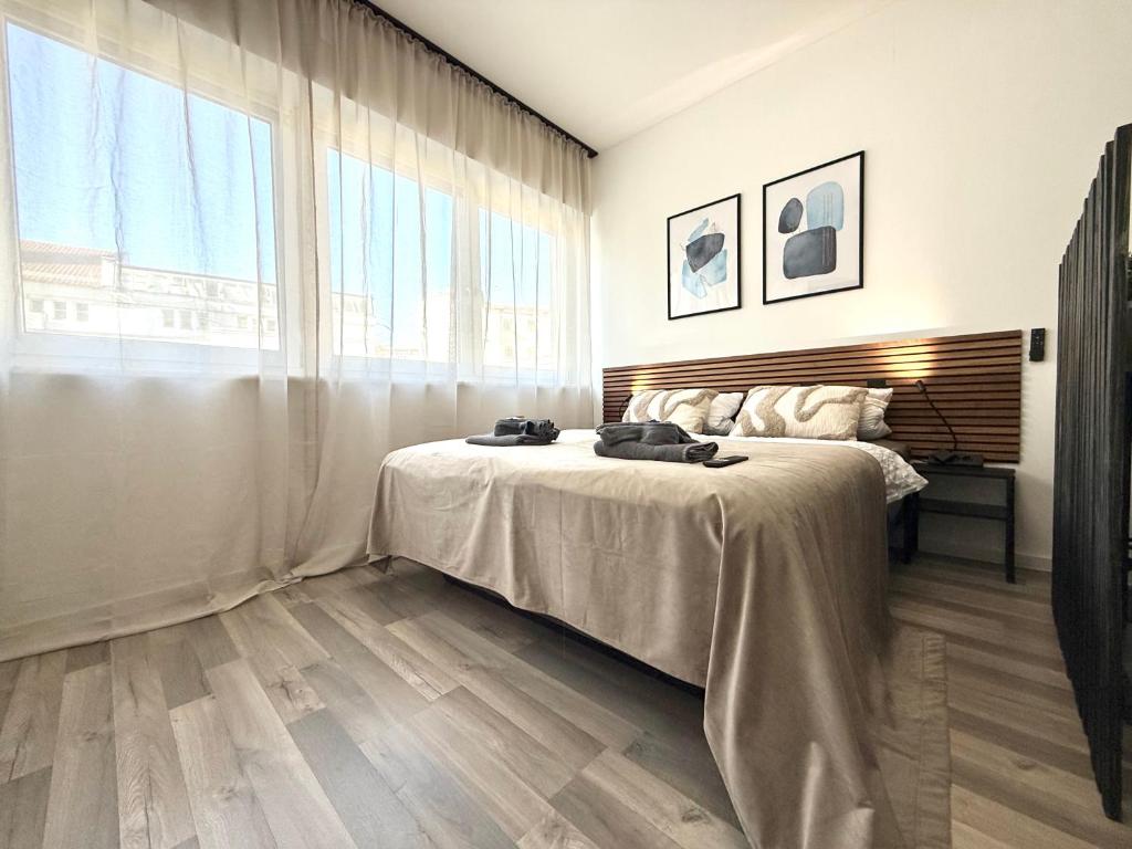a bedroom with a bed and a large window at Moderne Studio Wohnung in Stuttgart-Zentrum in Stuttgart