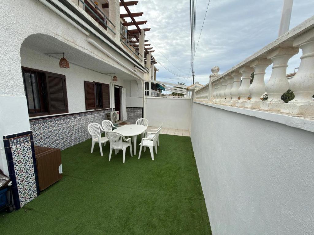 a patio with a table and chairs on a balcony at Flamingo Apartman in Torrevieja