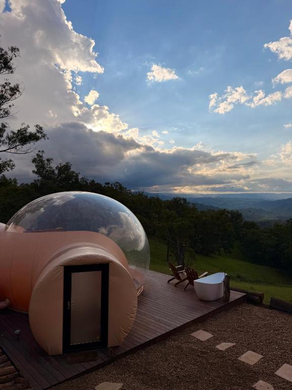 a large domed building on a deck with a view at Romantic Stargazing Getaway - Beyond Bubbles in Kanimbla