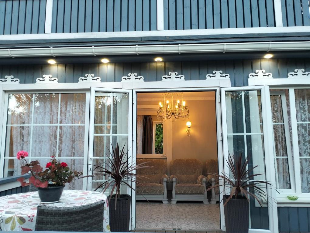 a screened in porch with a table and chairs at Apartment Sonata in Jūrmala