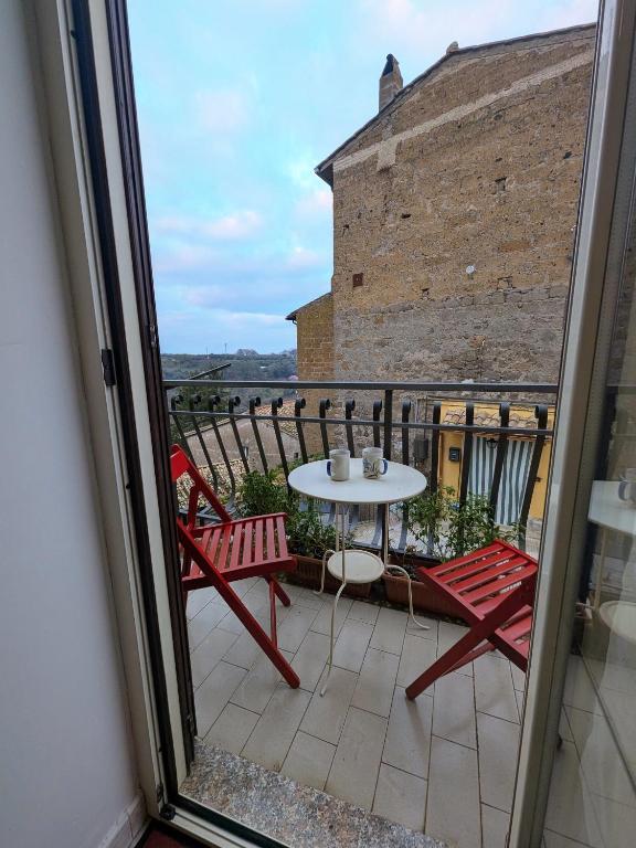 a balcony with a table and two chairs and a table at DaLu' tourist accommodation in Vallerano
