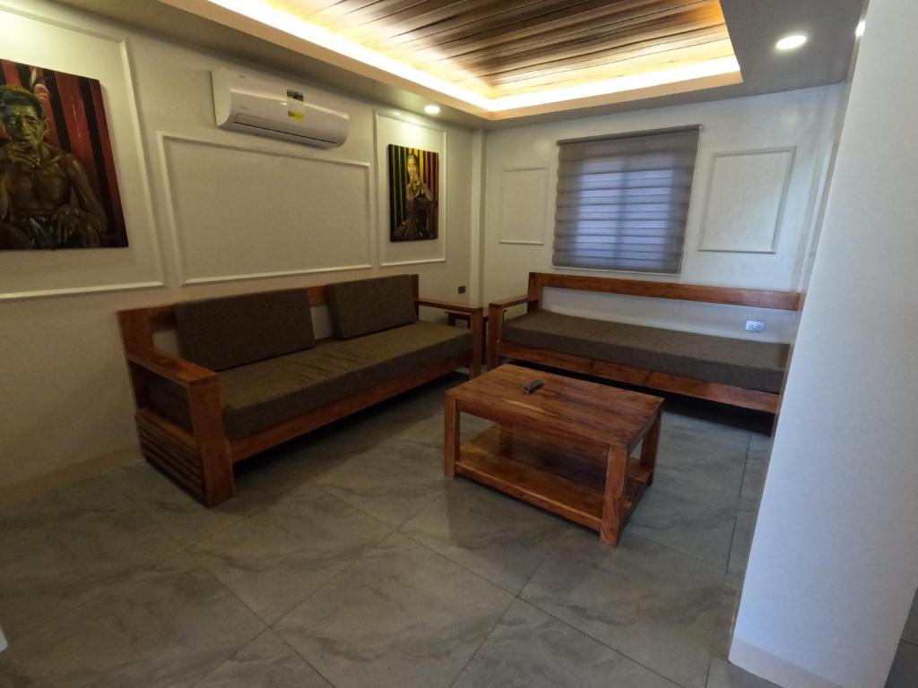 a living room with a couch and a table at Annie's Lodge Agoo in Agoo