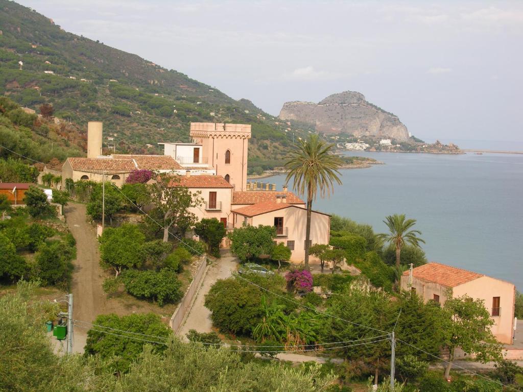 a town on a hill next to a body of water at Villa Palamara 1868-Toweronthesea in SantʼAmbrogio