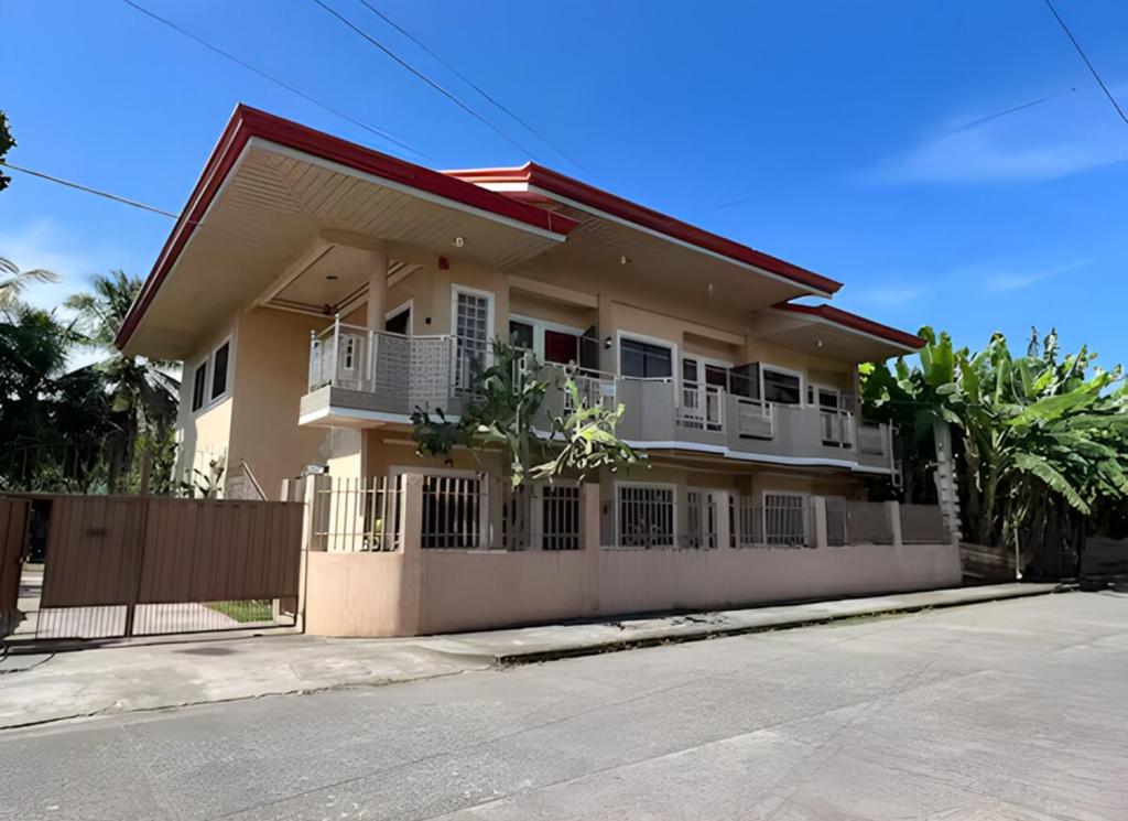 a house with a fence in front of it at Nielo's Apartment Door 4 in Dapitan