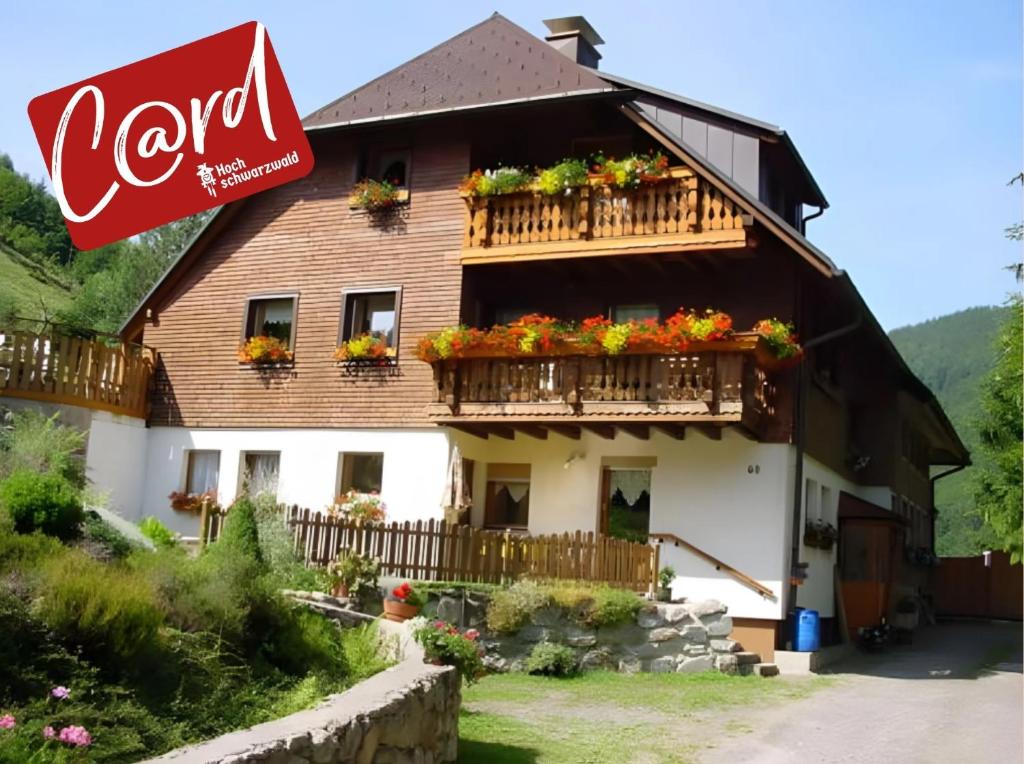 a large house with flowers on the balcony at Haus Maria in Todtnau