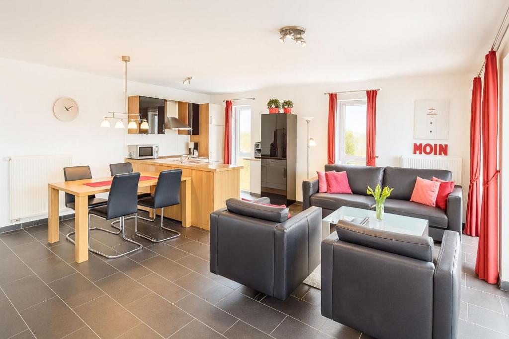 a living room with a couch and a table at Waterkant in Schillig
