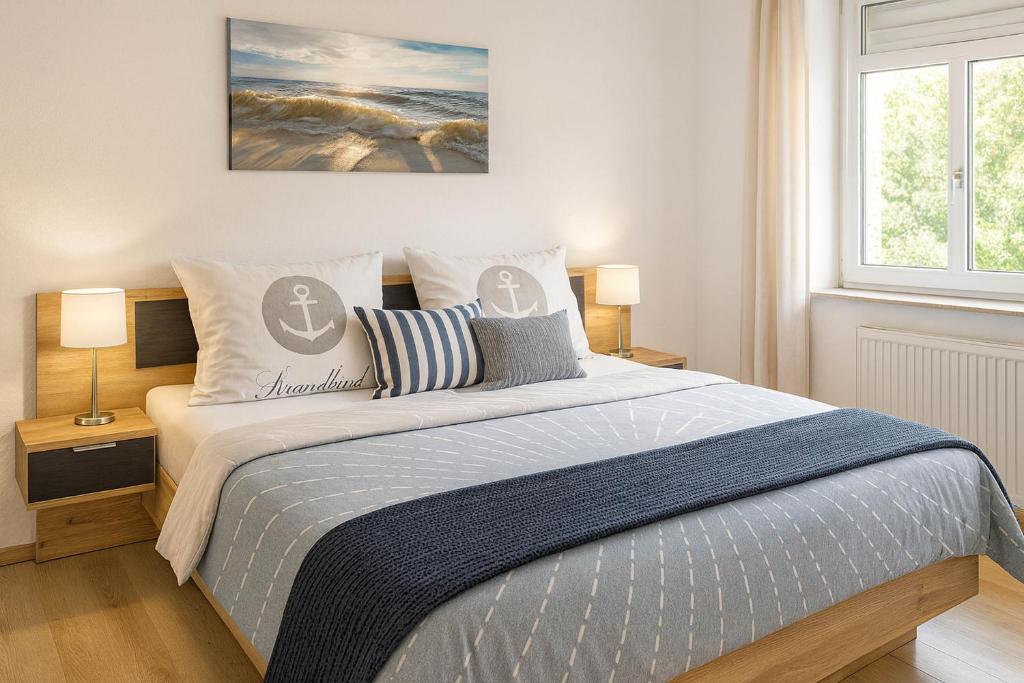 a bedroom with a large bed with two lamps at Boje 9 in Schillig