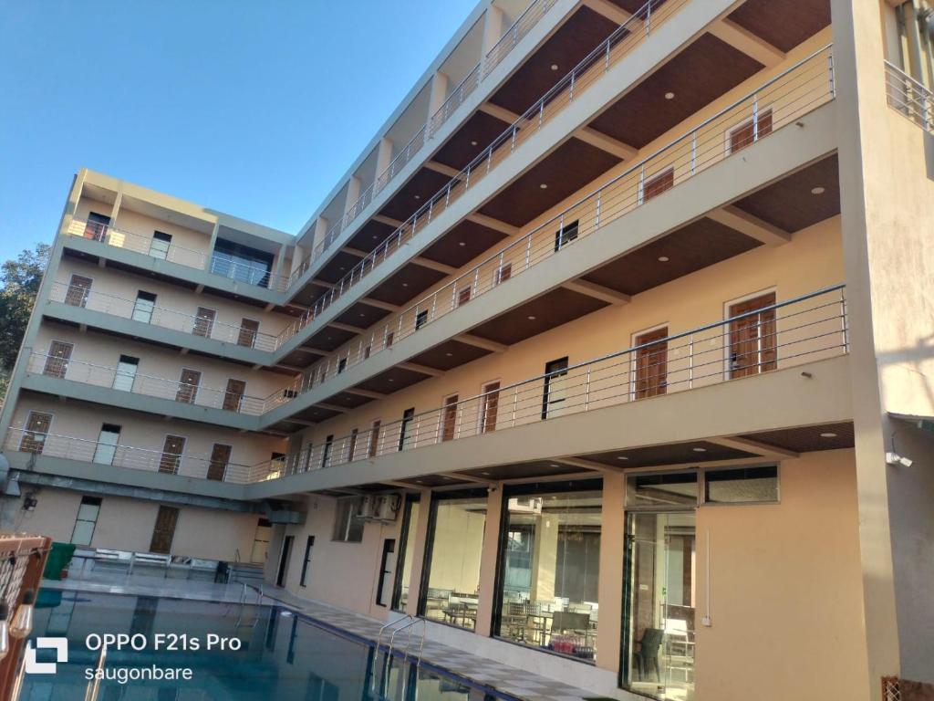 an external view of a building with a balcony at Saisha Palace Hotel, Ganpatipule in Ganpatipule