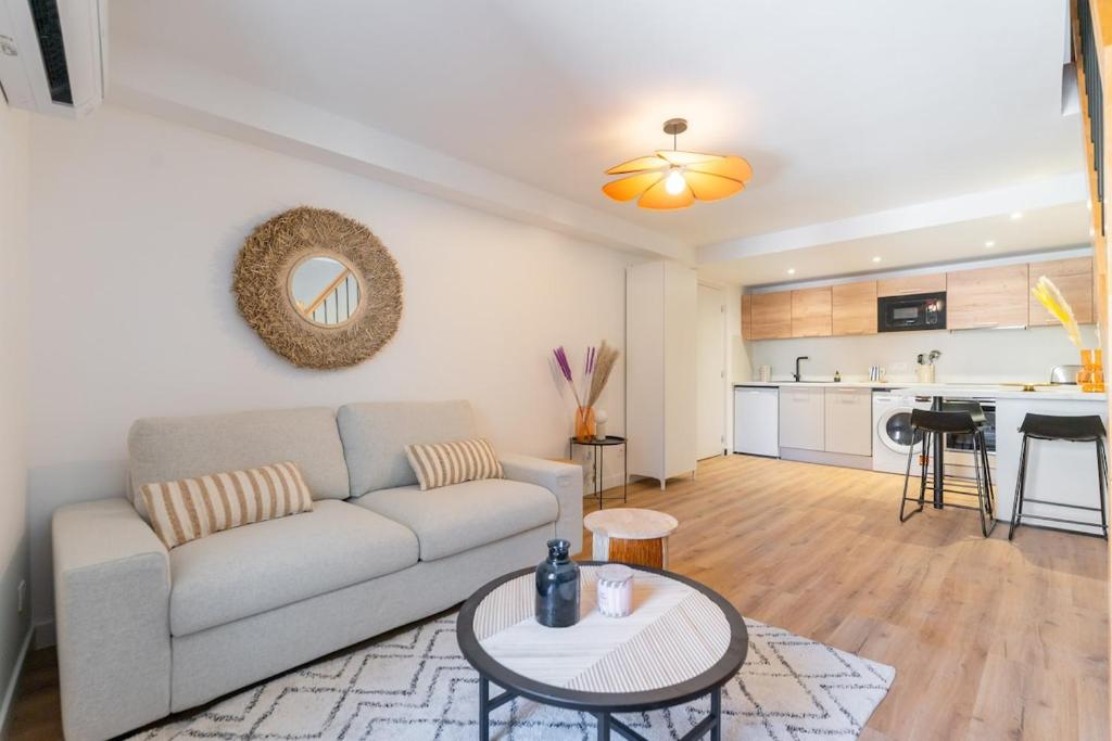 a living room with a couch and a table at Lavagnou Duplex in La Ciotat