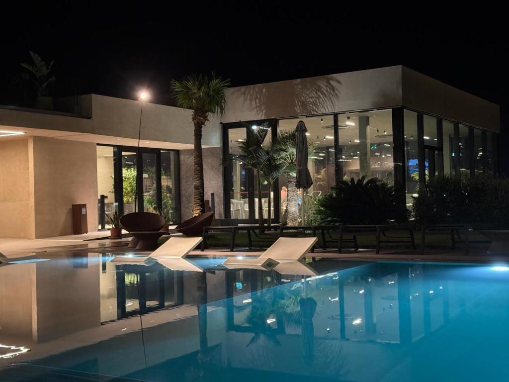 a swimming pool in front of a building at night at Terreforti Boutique Spa & Glamping in Agrigento