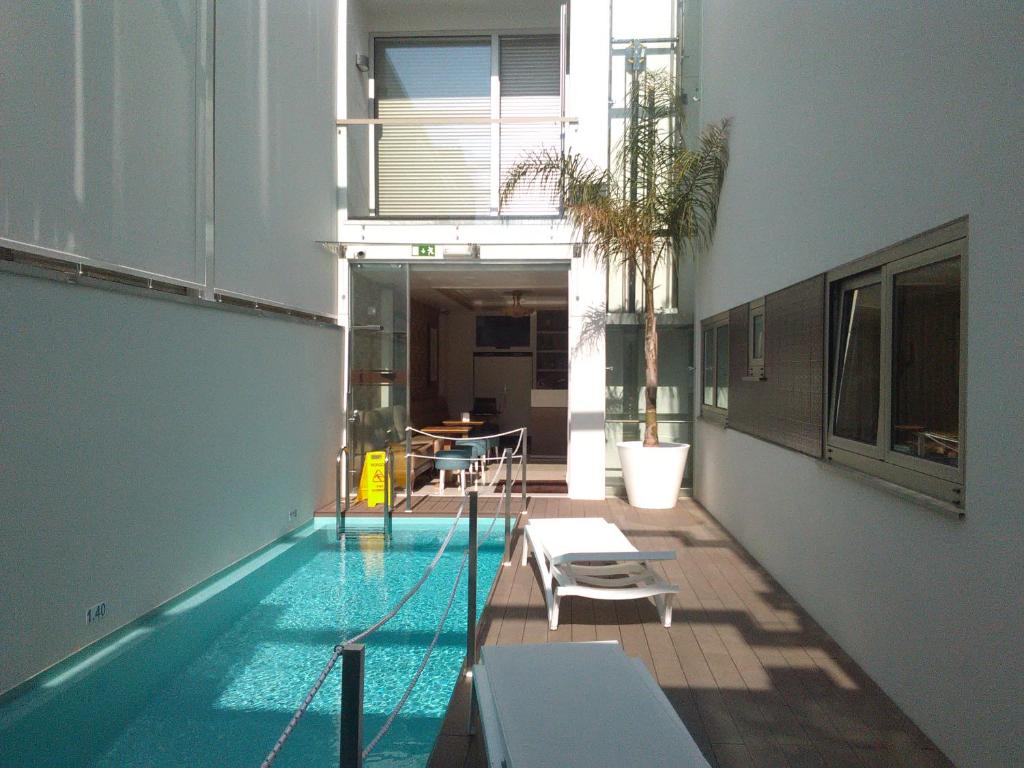 a swimming pool in the middle of a building at House Barra Beach in Praia da Barra
