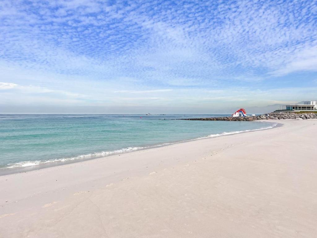 a beach with the ocean and a blue sky at FIRST CLASS Studio Beach View Living Bliss in Ras al Khaimah