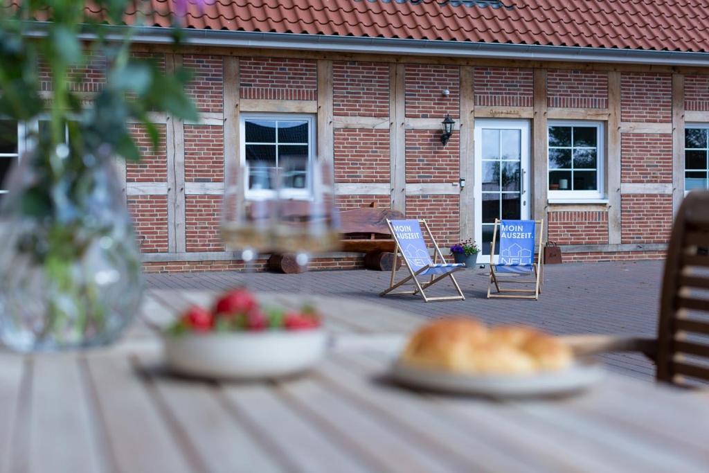 a table with a bowl of fruit and a plate of food at Fewo Wolke in Menslage