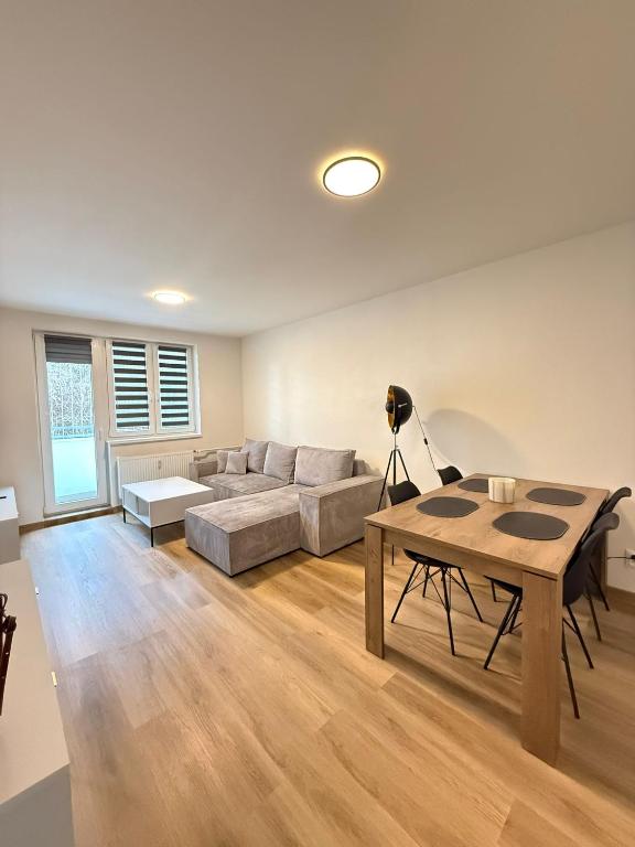a living room with a couch and a table at Mid-Town Spacious Apartment in Banská Bystrica