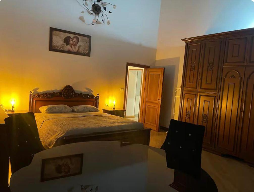 a bedroom with a bed and a table and a mirror at B&B Maria appartamento con stanza matrimoniale e soggiorno vicino alla fiera 2 in Rimini