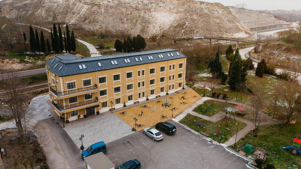 an overhead view of a yellow building with a parking lot at Port Lake Hotel in Beloslav