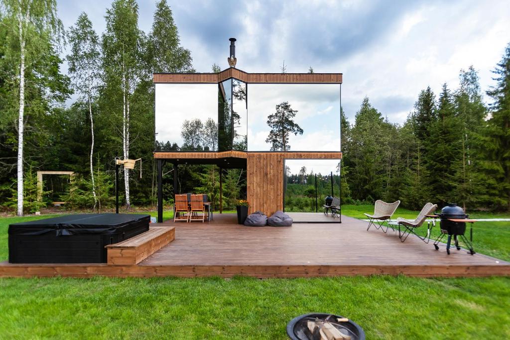 a large wooden deck with a grill and chairs at Luxury Resort Orava in Orava