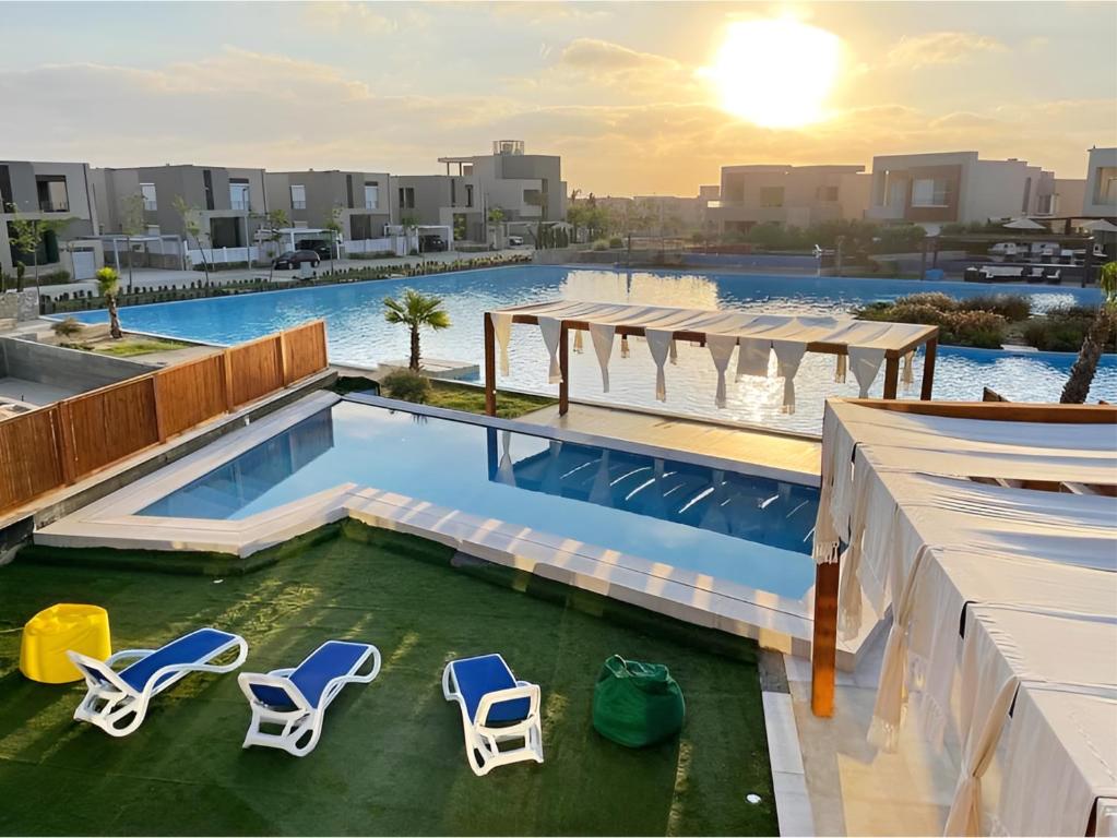 a swimming pool with lounge chairs and a swimming poolvisor at Villa private pool with view Lagoon Rooms in Sīdī ‘Abd ar Raḩmān