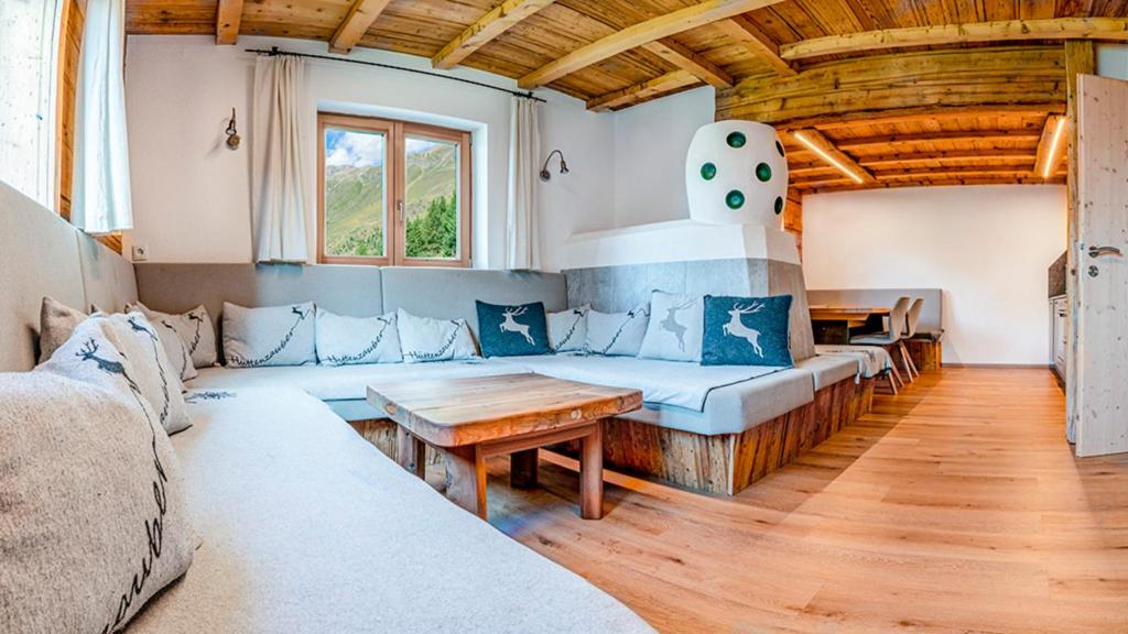 a living room with a couch and a table at Berghütte Kneisl in Sölden