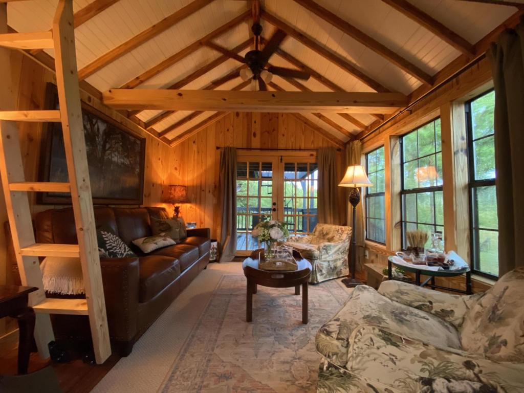 a living room with a loft bed in a cabin at Little Pine Lodge At Saddlecreek in Thomasville