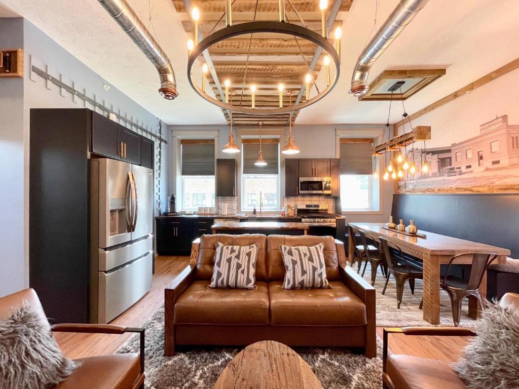 a living room with a couch and a table at Historical Boiler Maker Turns Vacation Destination in Muskegon