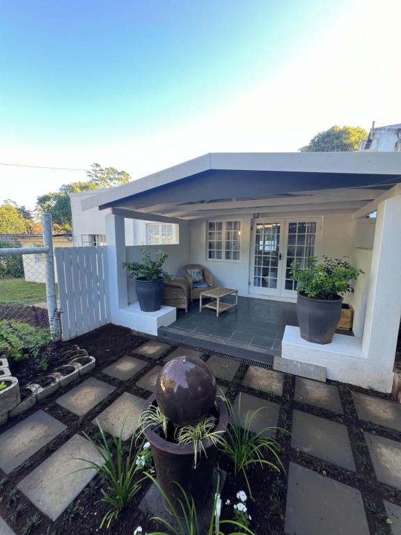 a small house with a patio with plants at Maple and Vine in Hilton