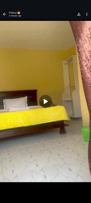 a bedroom with a bed with a yellow bedspread at Mara gause hoise in Mara Simba