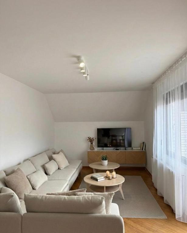 a living room with a couch and a table at Cozy Apartment with Balcony in Ivanjica