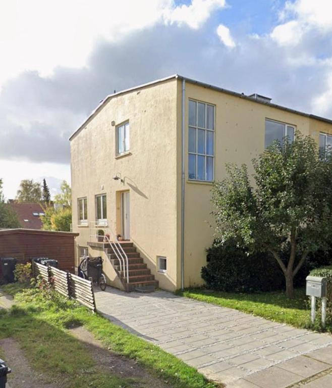 a building with stairs and a bike parked in front of it at Cozy and Spacious Guest Room, Virum in Virum