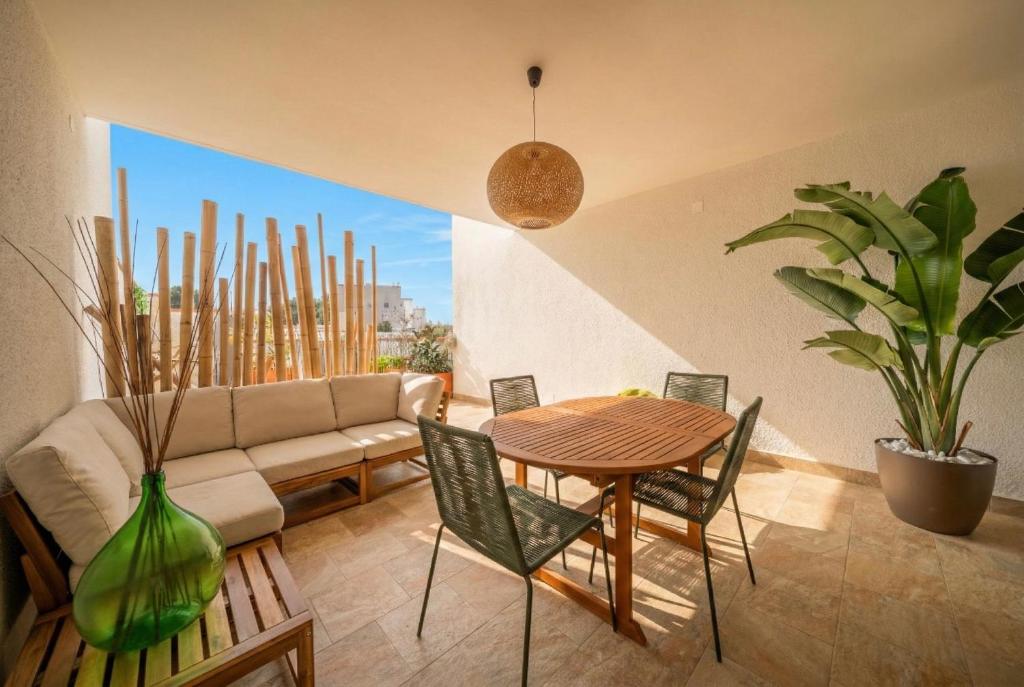a living room with a couch and a table and chairs at La Dimora del Sole in Monopoli