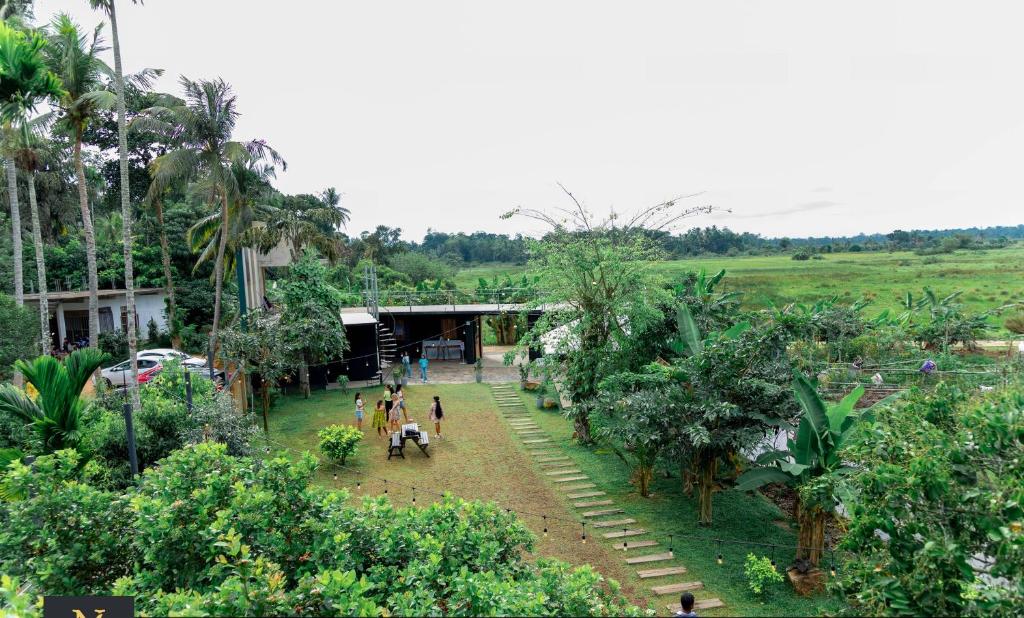 a group of people standing in a garden at Villa Nelith in Galle