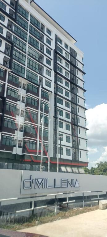 a tall building with a sign in front of it at D'Millenia Residences Steady in Kota Samarahan